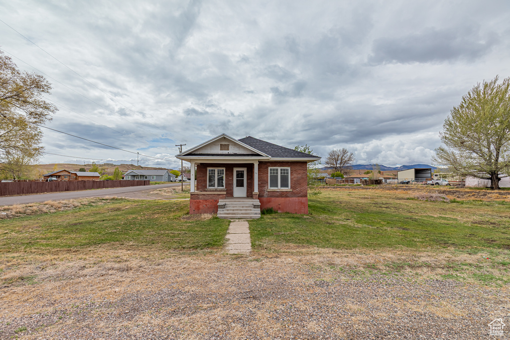 View of front of home with brick siding and covered porch