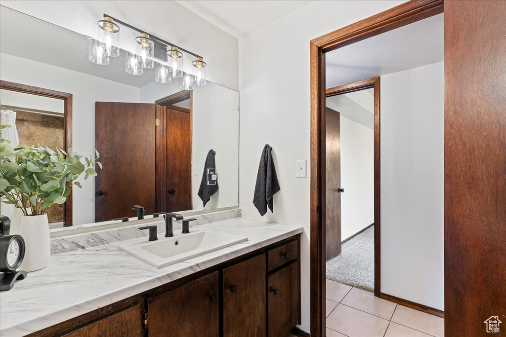 Bathroom with tile patterned floors and vanity