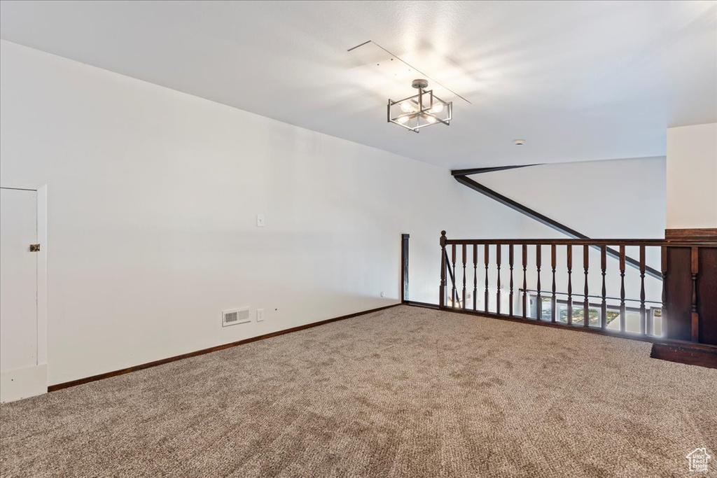 Additional living space featuring carpet flooring and baseboards