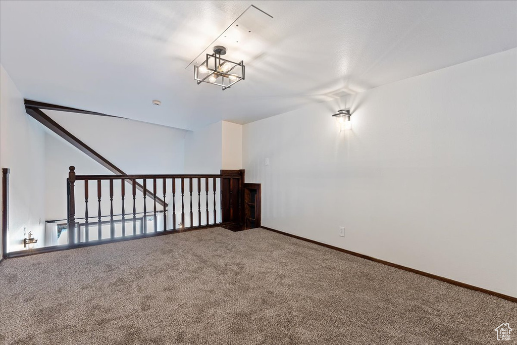 Bonus room with carpet flooring and baseboards