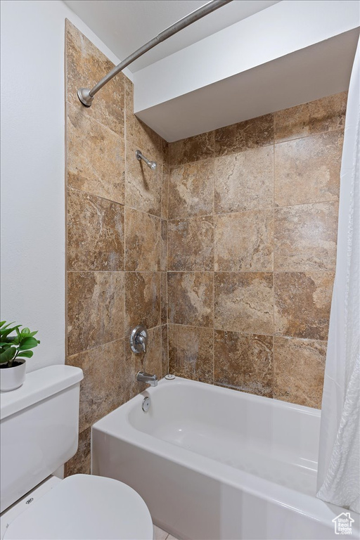 Full bathroom featuring toilet and shower / tub combo