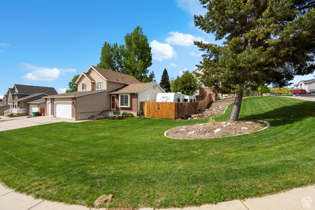 View of front of house featuring concrete driveway, an attached garage, brick siding, and stucco siding