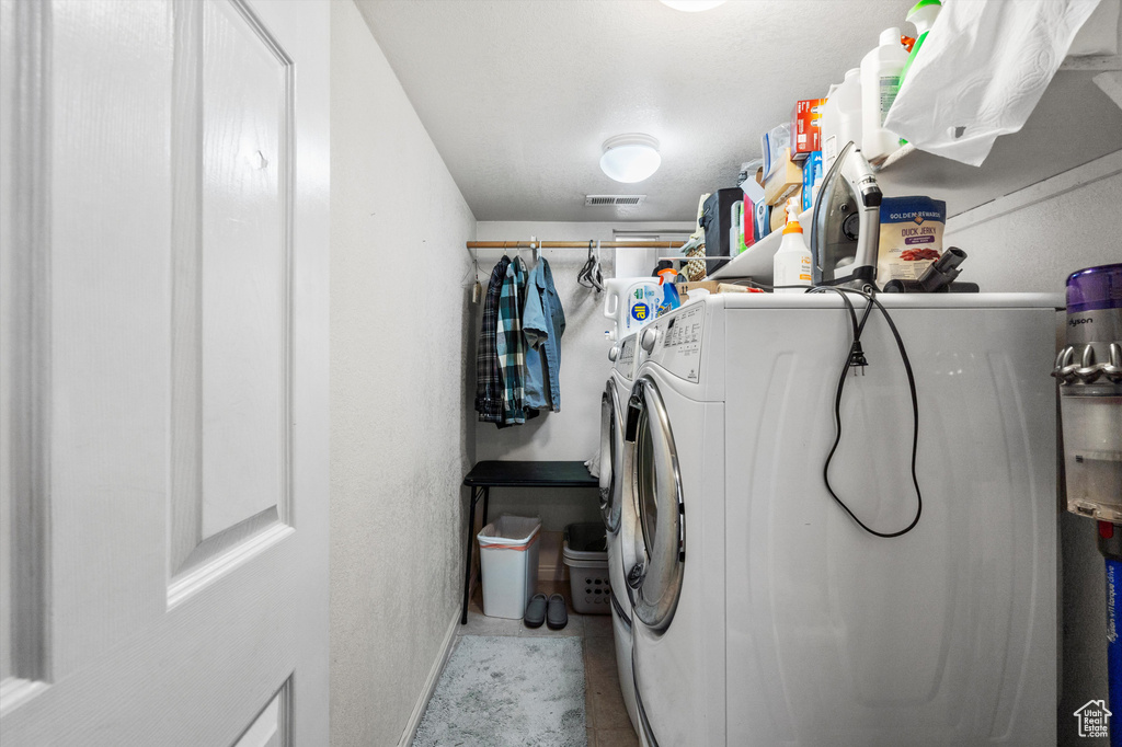 Laundry area featuring washer and clothes dryer and baseboards
