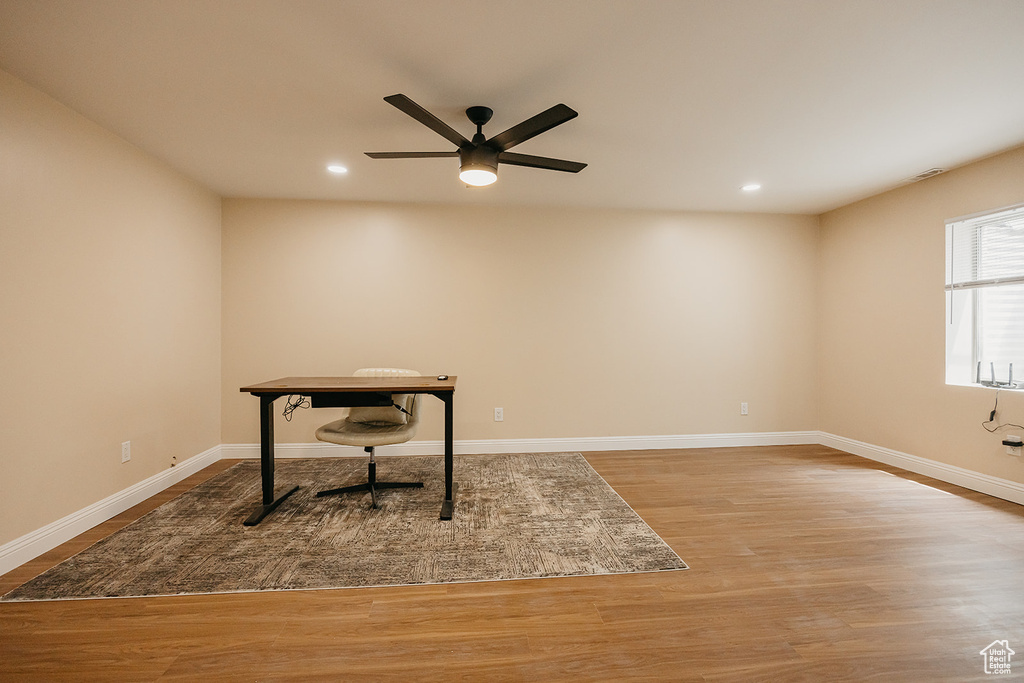 Unfurnished office with ceiling fan, recessed lighting, baseboards, and wood finished floors