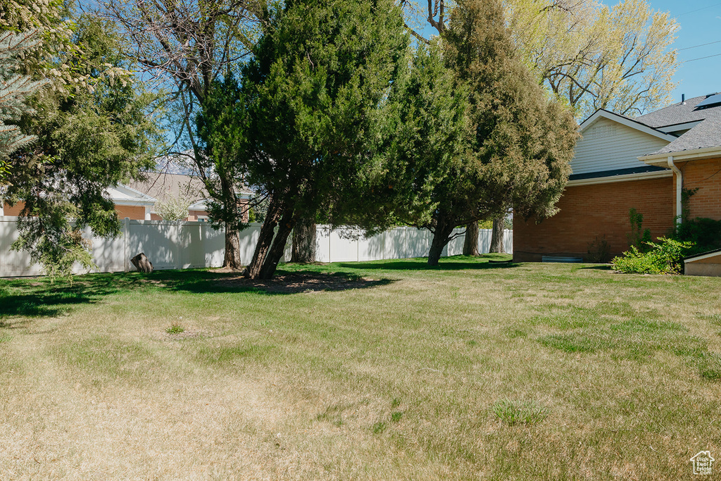 View of yard featuring fence