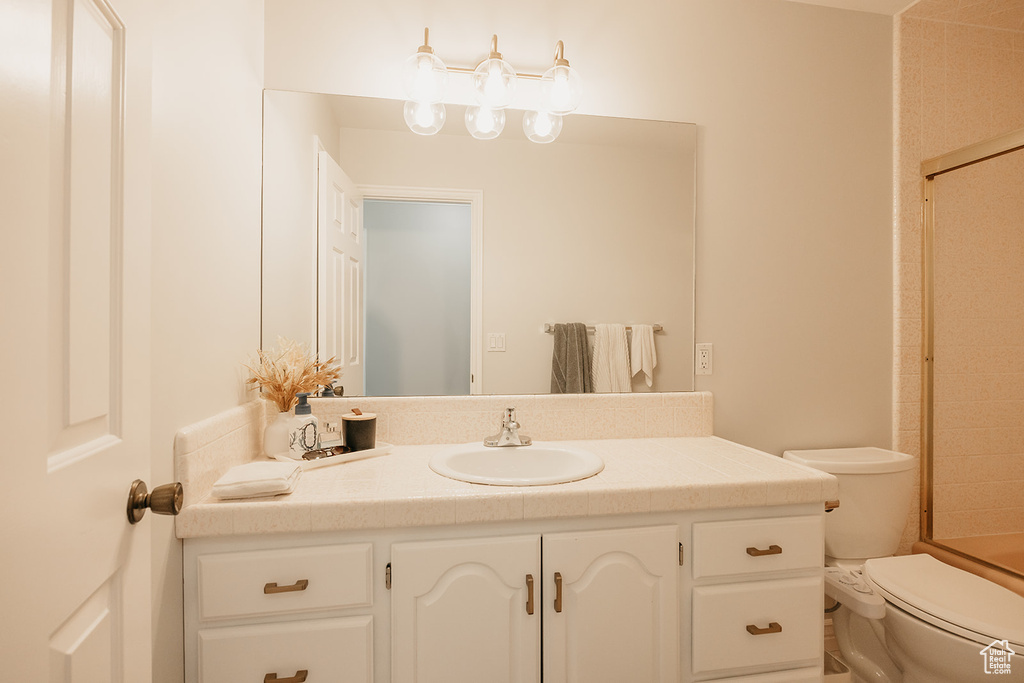 Full bath featuring vanity and toilet