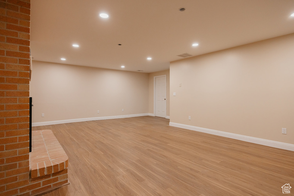 Basement featuring recessed lighting and light wood-type flooring