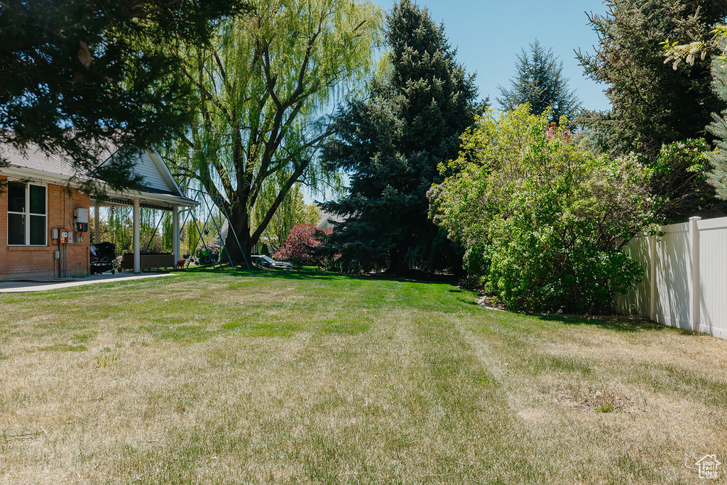 View of yard featuring fence