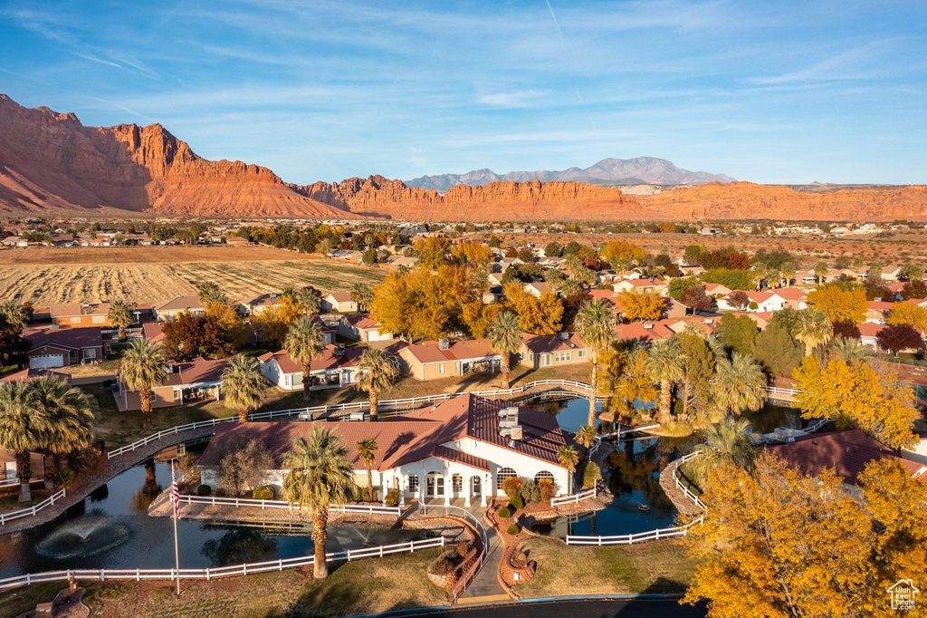 Aerial view of property's location featuring nearby suburban area and a water and mountain view