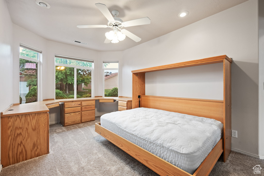 Bedroom with light colored carpet, a desk, recessed lighting, and ceiling fan