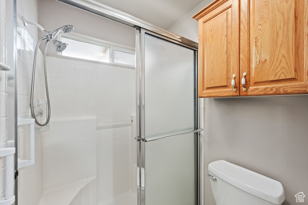 Full bath with a shower stall and toilet