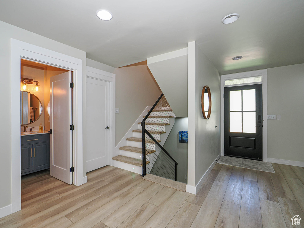 Entryway with light wood-style floors, baseboards, stairway, and recessed lighting