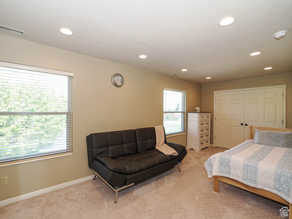Bedroom with light carpet, recessed lighting, and baseboards