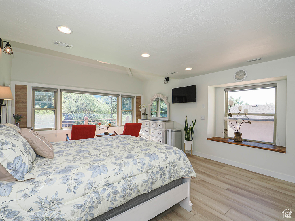 Bedroom with light wood-style flooring, recessed lighting, and baseboards
