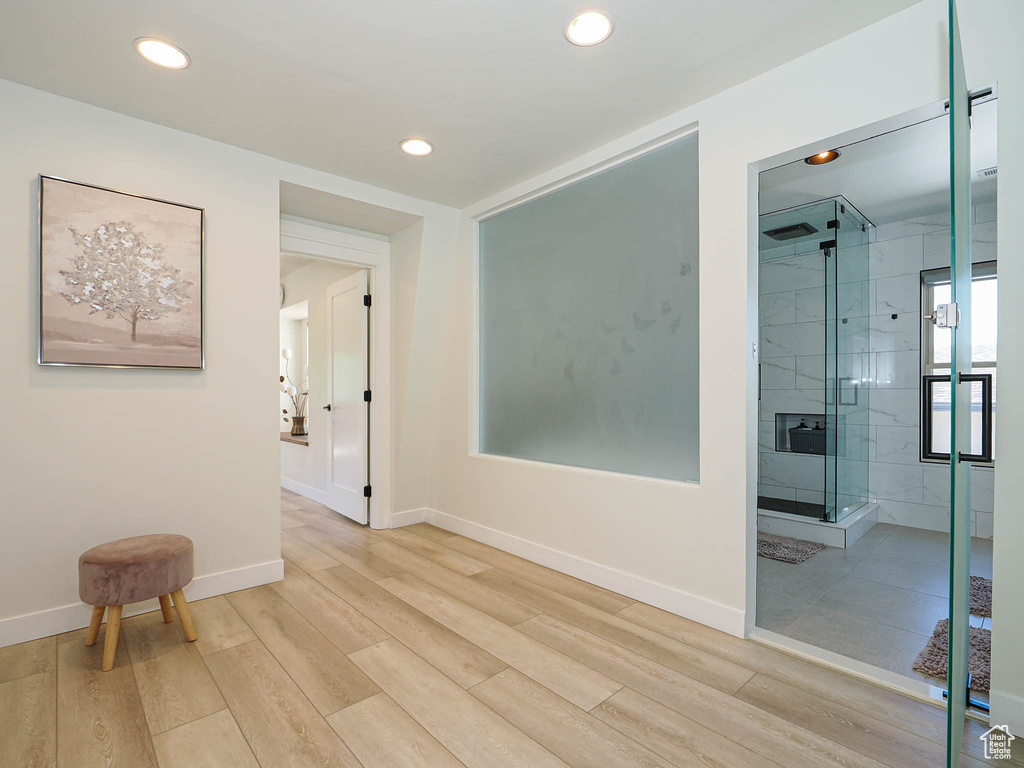 Hall featuring light wood finished floors, recessed lighting, and baseboards