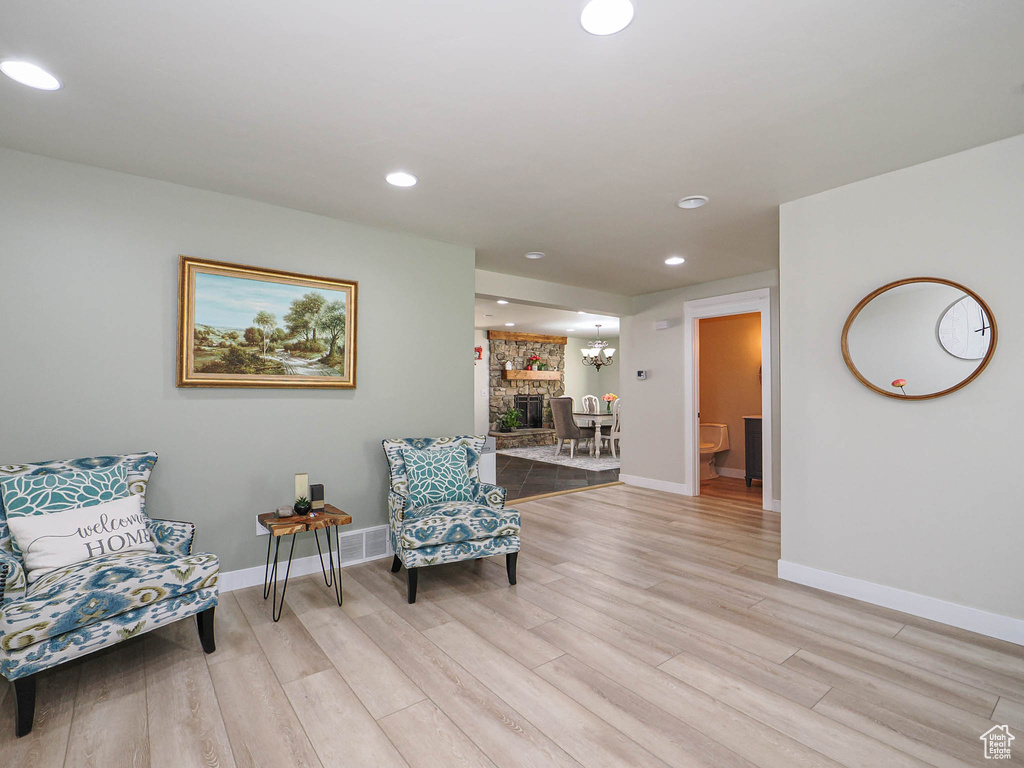 Living area featuring light wood finished floors, baseboards, and recessed lighting