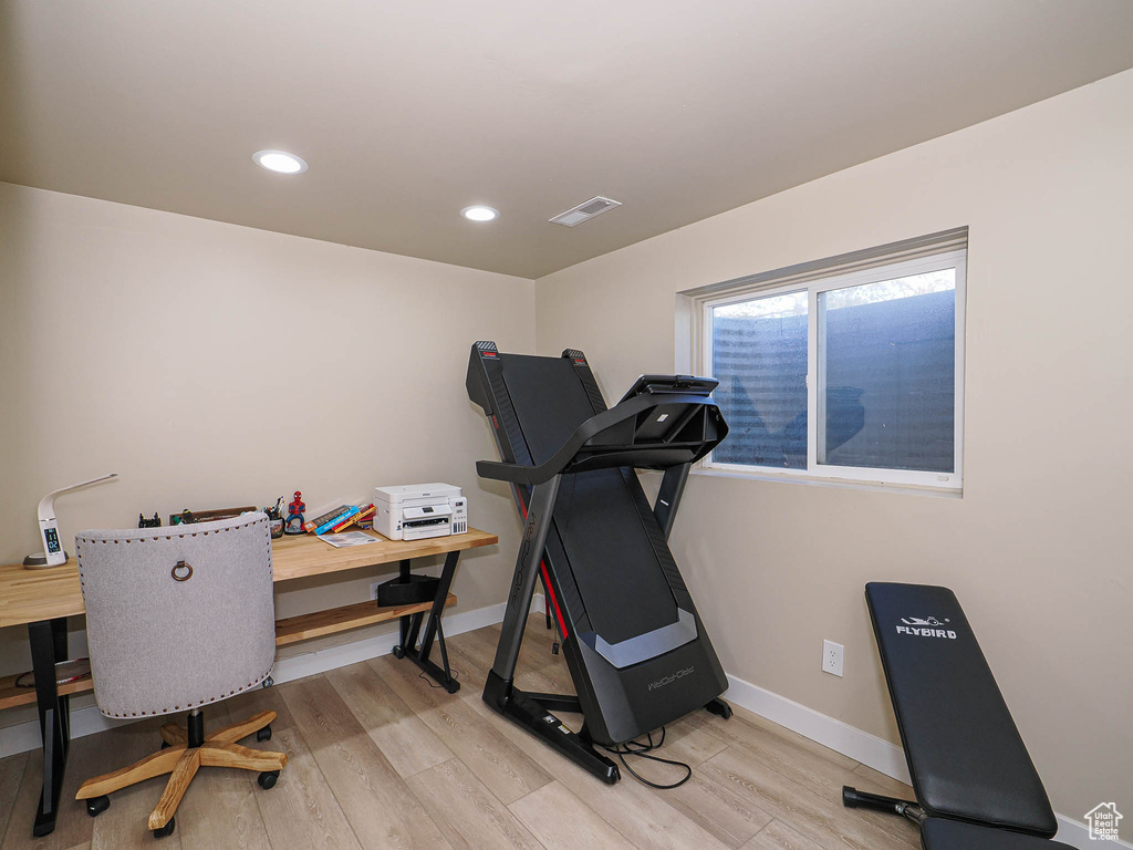 Workout area with light wood-style flooring, baseboards, and recessed lighting