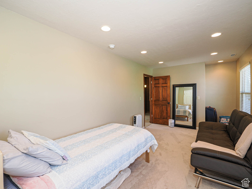 Bedroom with light carpet and recessed lighting