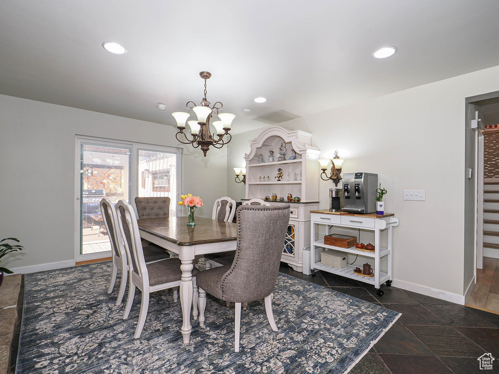 Dining space featuring a chandelier, baseboards, recessed lighting, and stairs