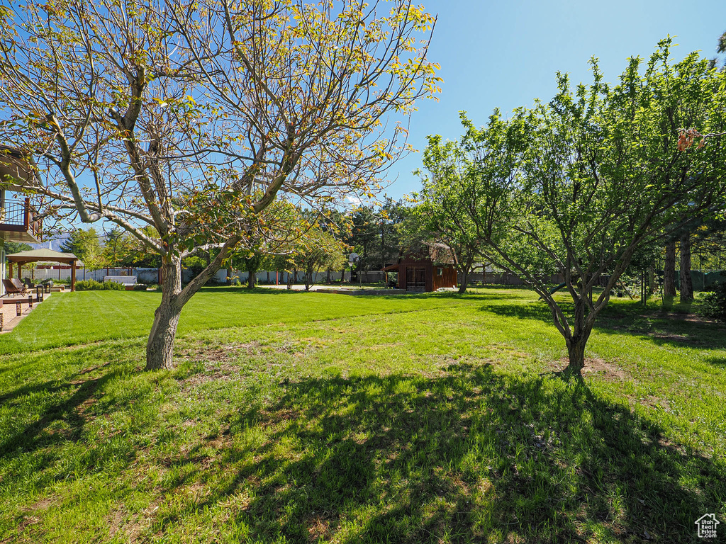 View of grassy yard featuring a gazebo