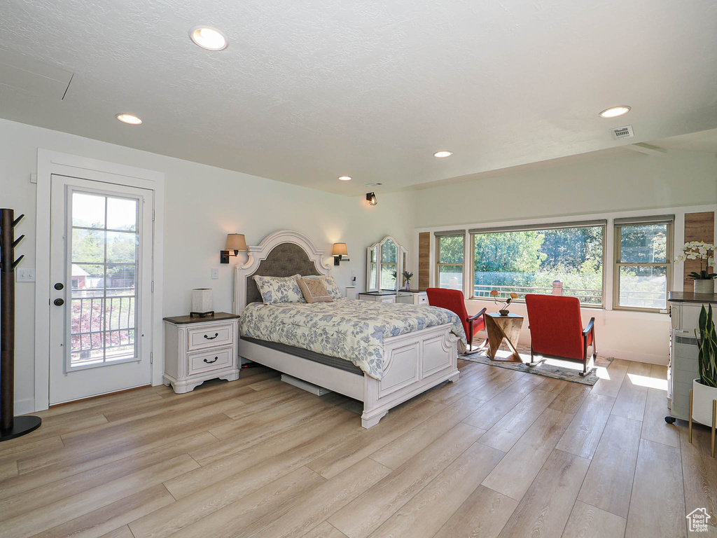 Bedroom with light wood-style flooring, access to outside, and recessed lighting