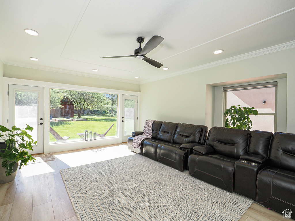 Living area with a ceiling fan, wood finished floors, recessed lighting, and ornamental molding
