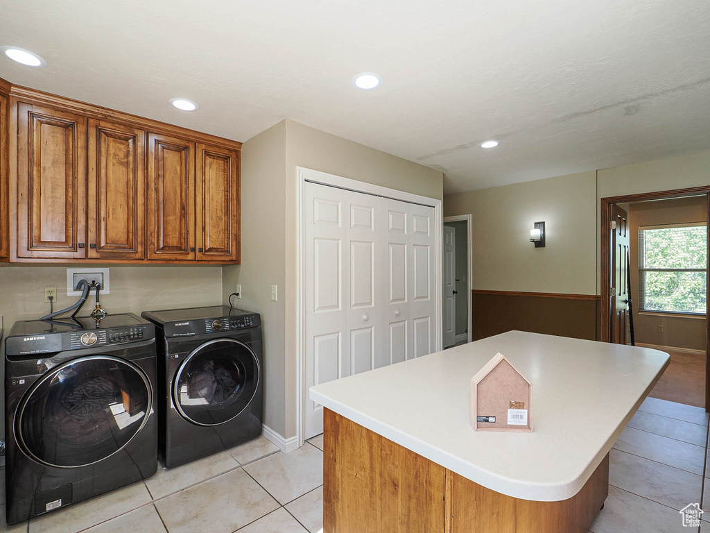 Clothes washing area featuring independent washer and dryer, cabinet space, light tile patterned floors, and recessed lighting