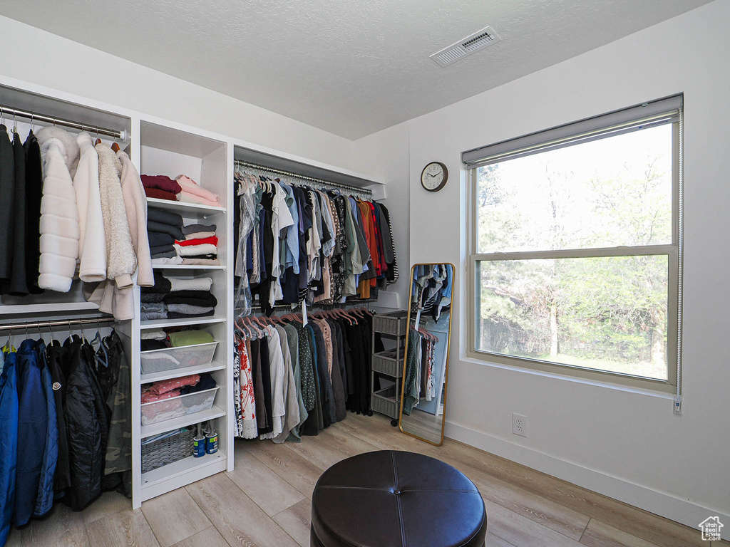 Walk in closet featuring wood finished floors