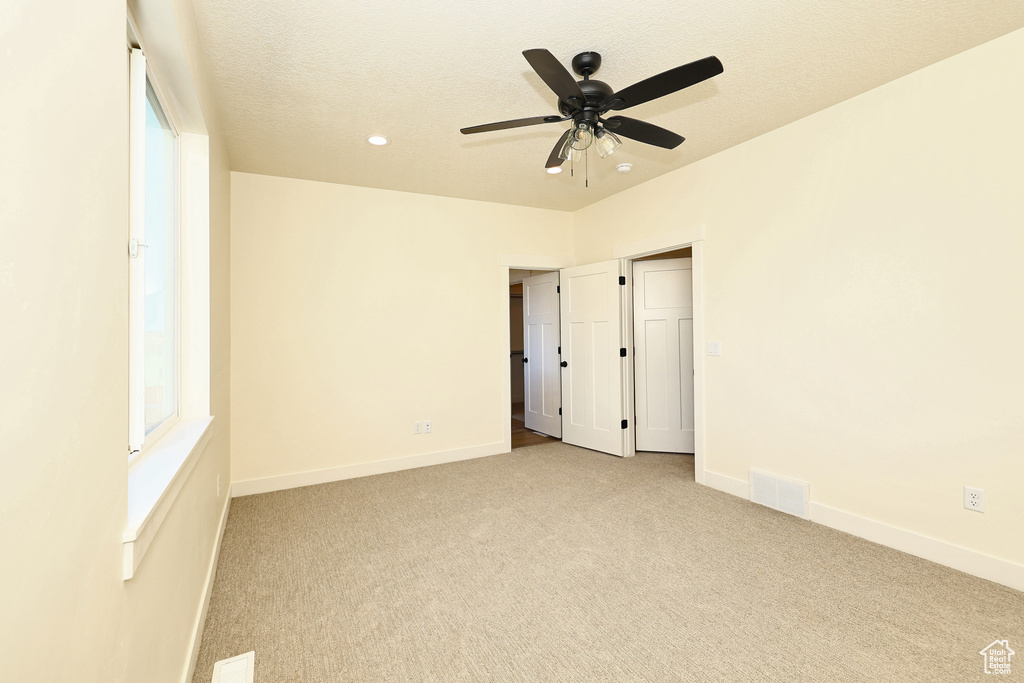 Unfurnished bedroom featuring carpet floors, baseboards, recessed lighting, and ceiling fan