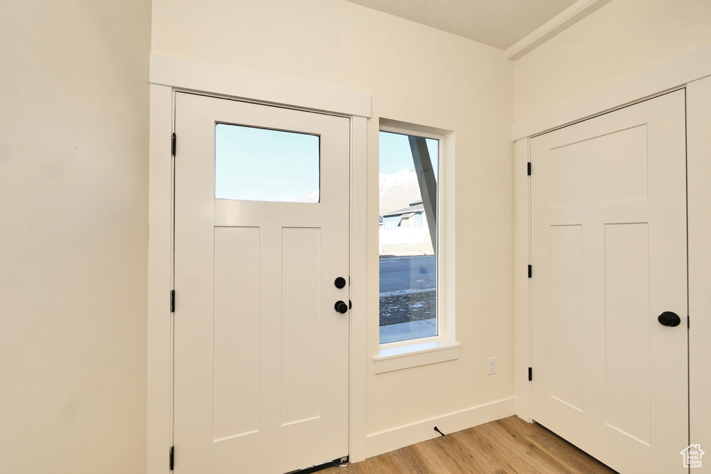 Entryway with plenty of natural light, light wood-style flooring, and baseboards