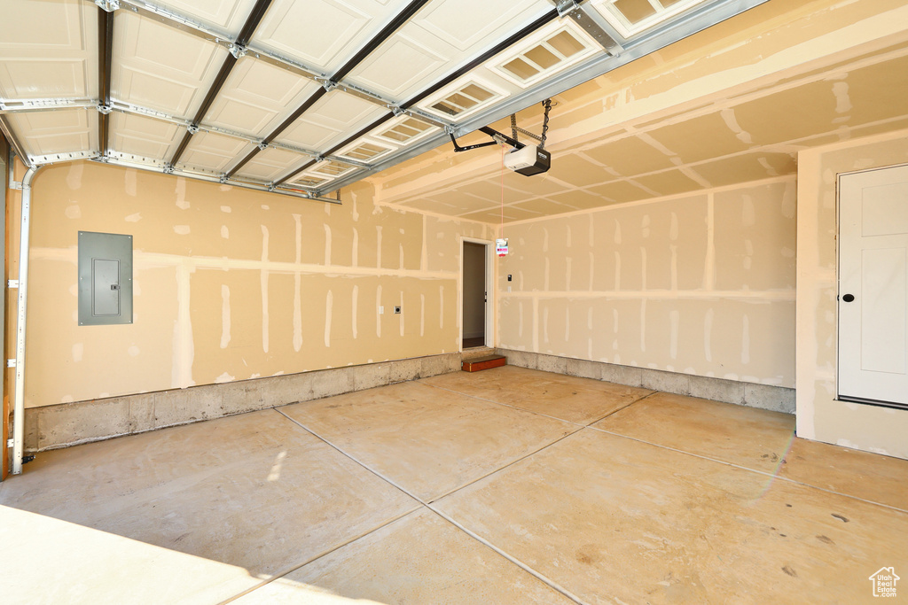 Garage with electric panel and a garage door opener