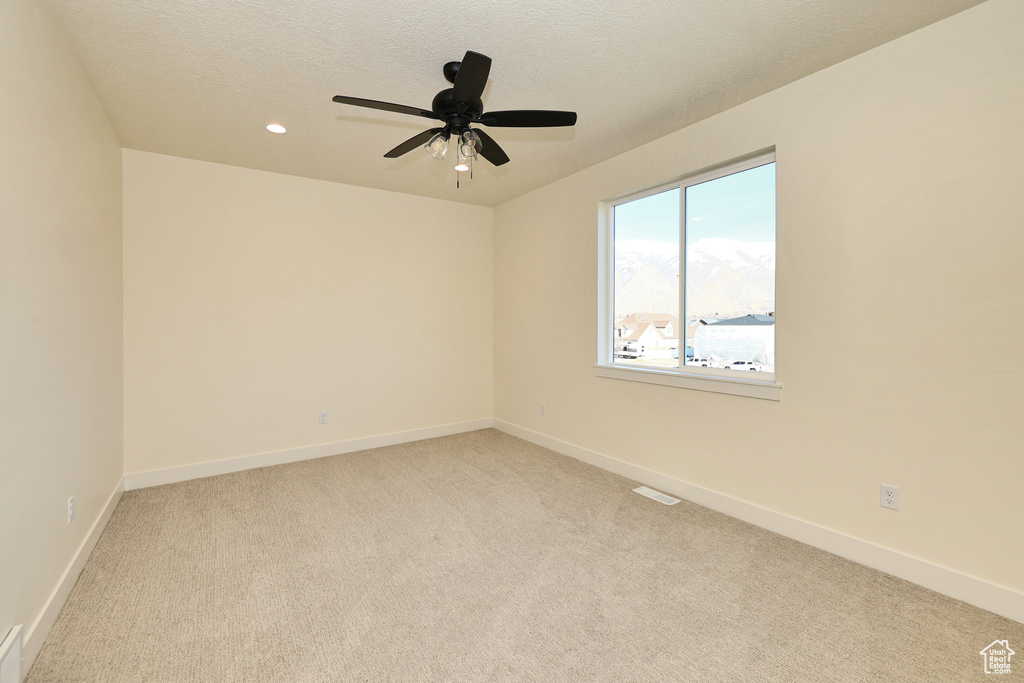 Unfurnished room with light carpet, baseboards, recessed lighting, ceiling fan, and a textured ceiling