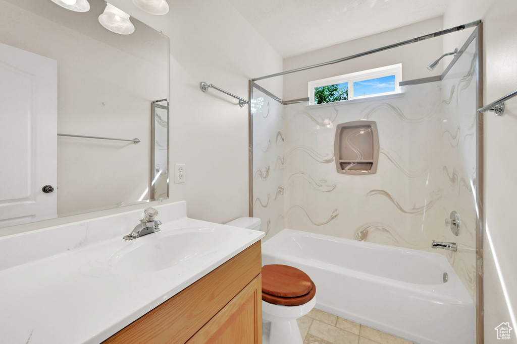 Full bath with toilet, bathtub / shower combination, vanity, and tile patterned floors