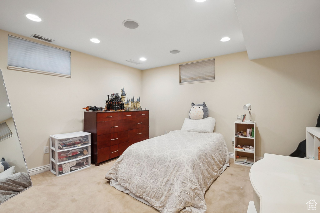 Bedroom with light colored carpet, recessed lighting, and baseboards