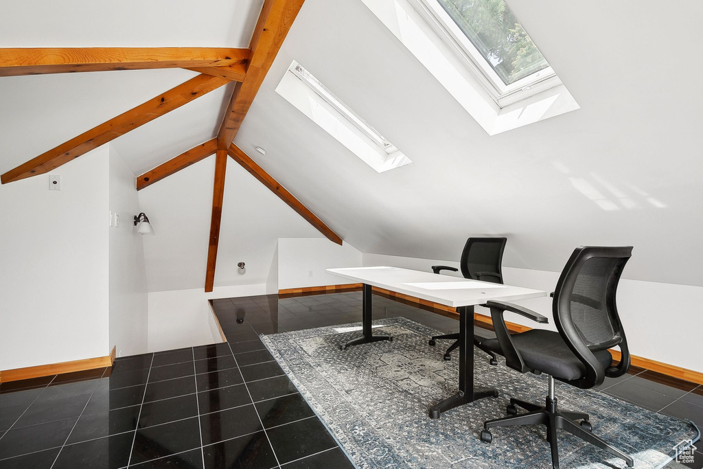 Tiled home office with a skylight and lofted ceiling
