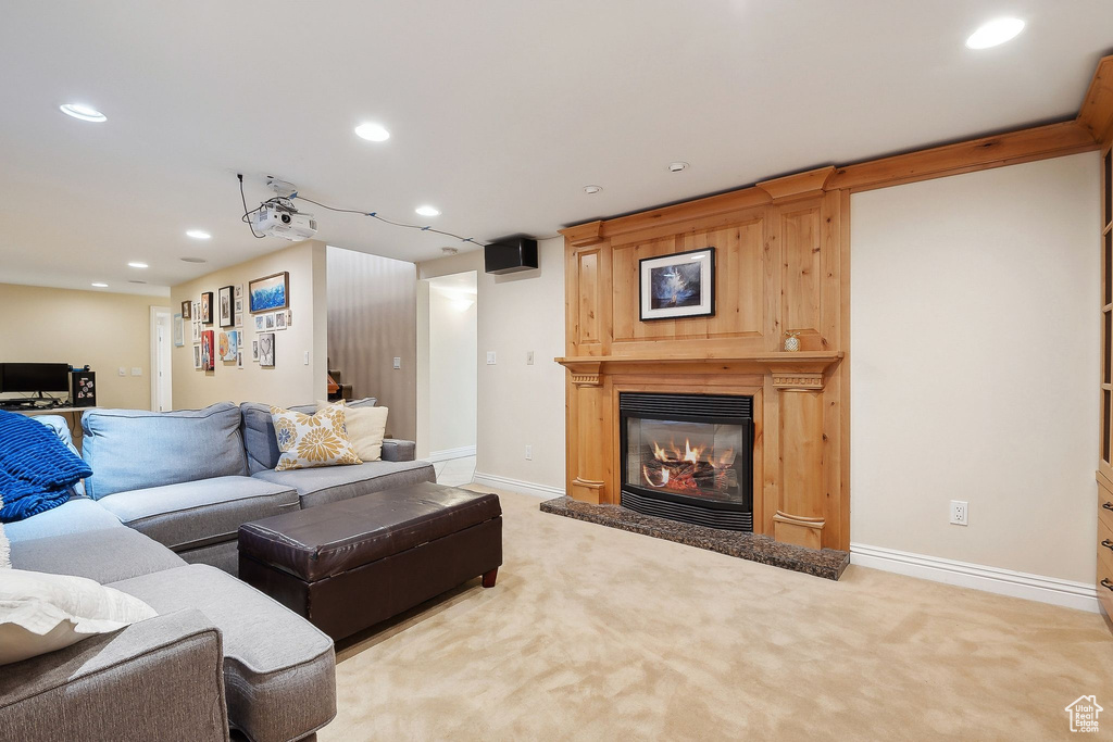 Living area featuring recessed lighting, carpet, a glass covered fireplace, and baseboards