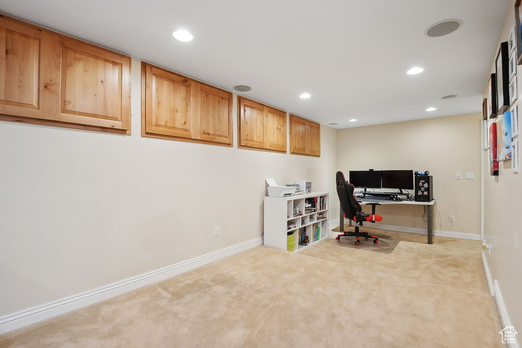 Carpeted office space with recessed lighting and baseboards