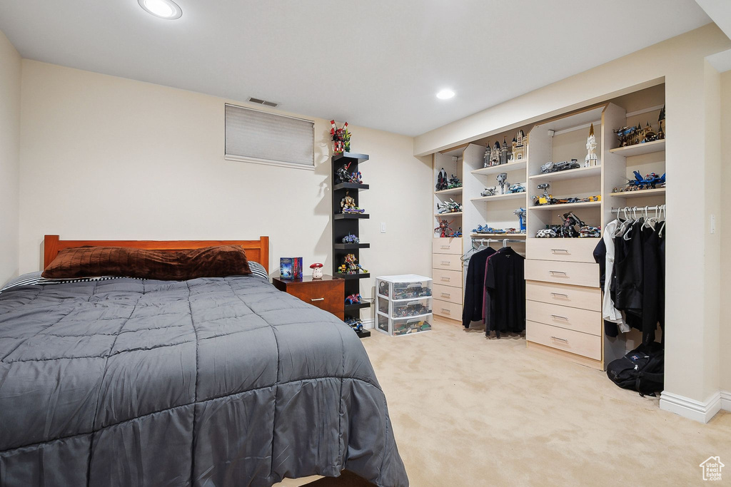 Bedroom featuring light colored carpet, recessed lighting, a closet, and baseboards
