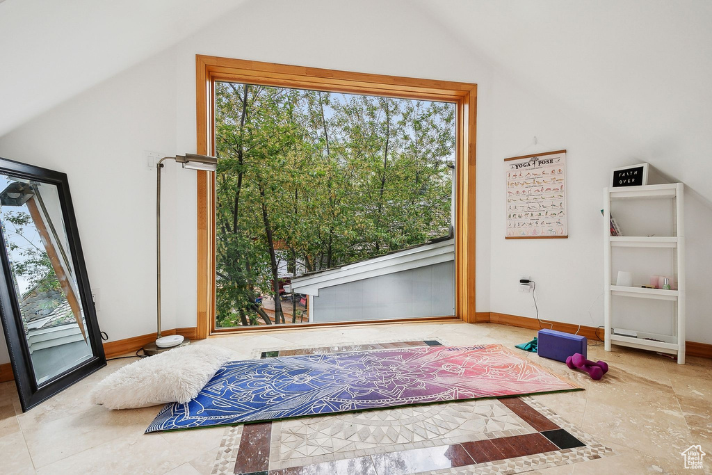 Bedroom featuring vaulted ceiling and baseboards