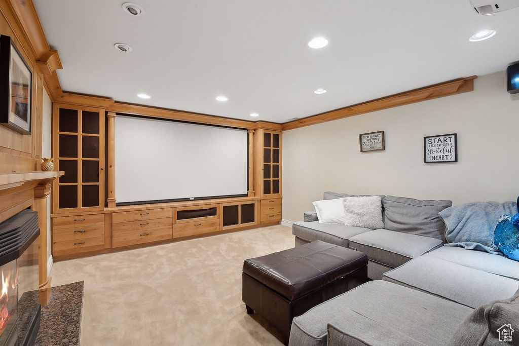 Cinema room with a fireplace with flush hearth, recessed lighting, and light carpet