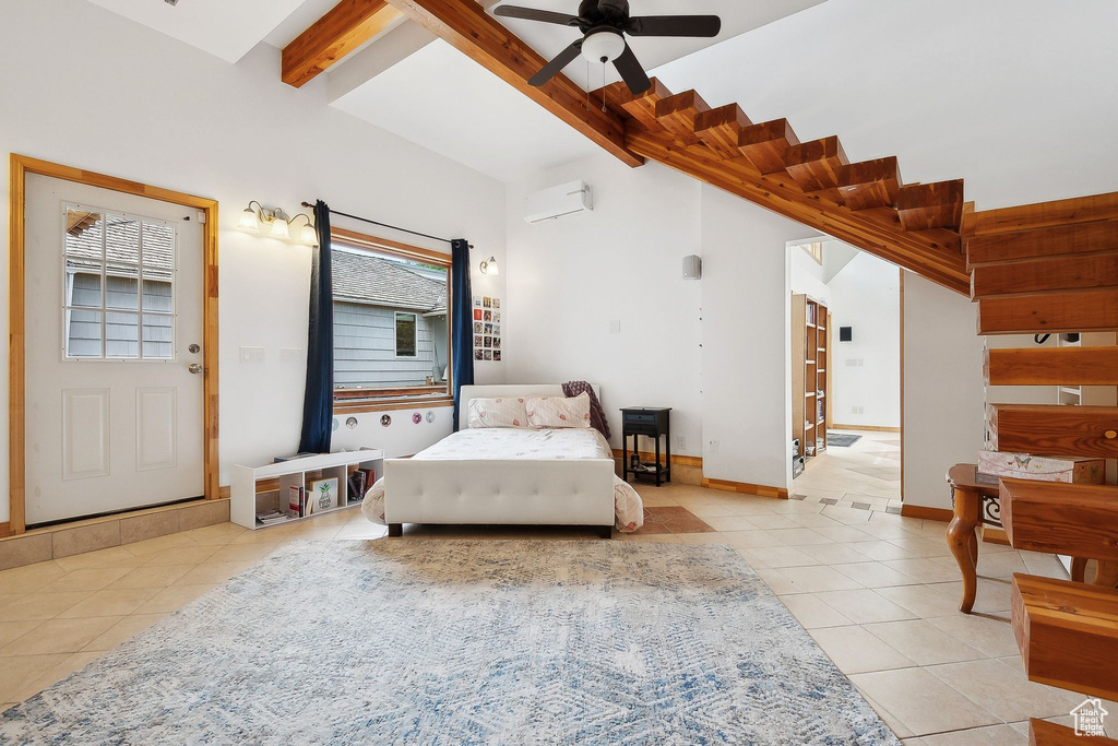 Bedroom with light tile patterned floors, an AC wall unit, and baseboards