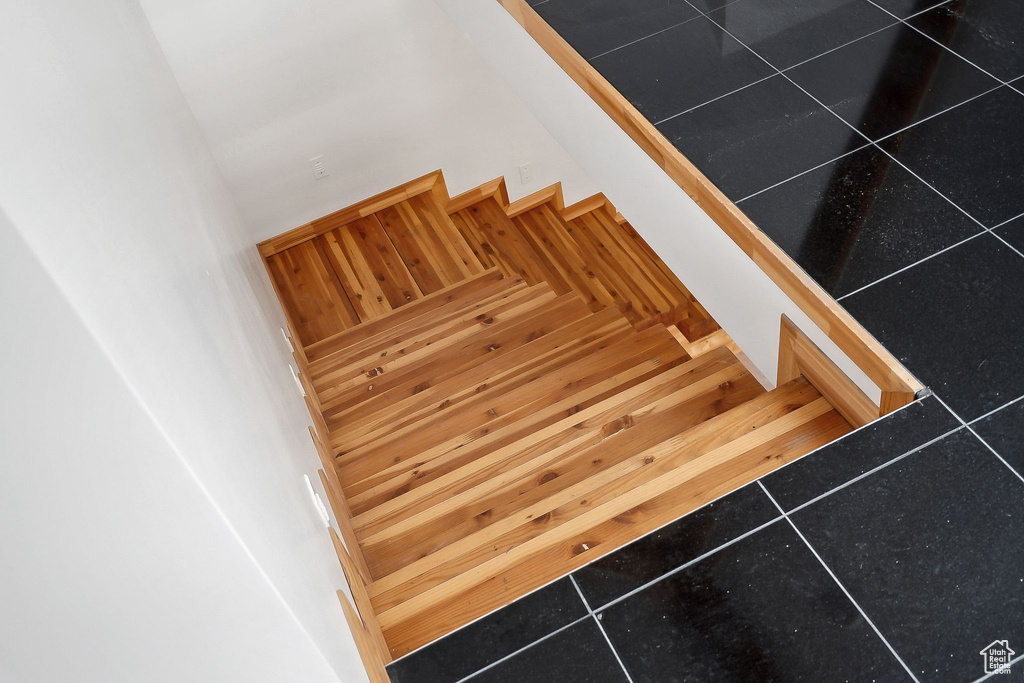 Stairs featuring tile patterned floors