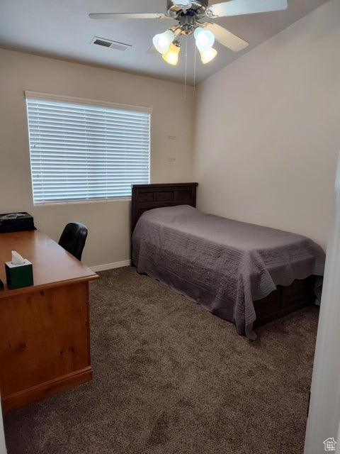 Bedroom featuring carpet flooring, baseboards, an office area, and a ceiling fan