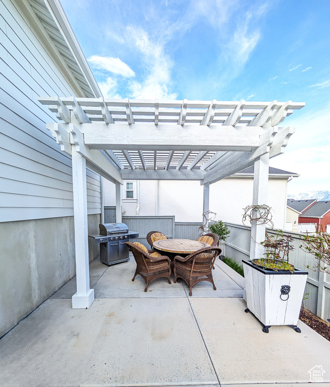 View of patio / terrace featuring a grill, a pergola, outdoor dining area, and fence
