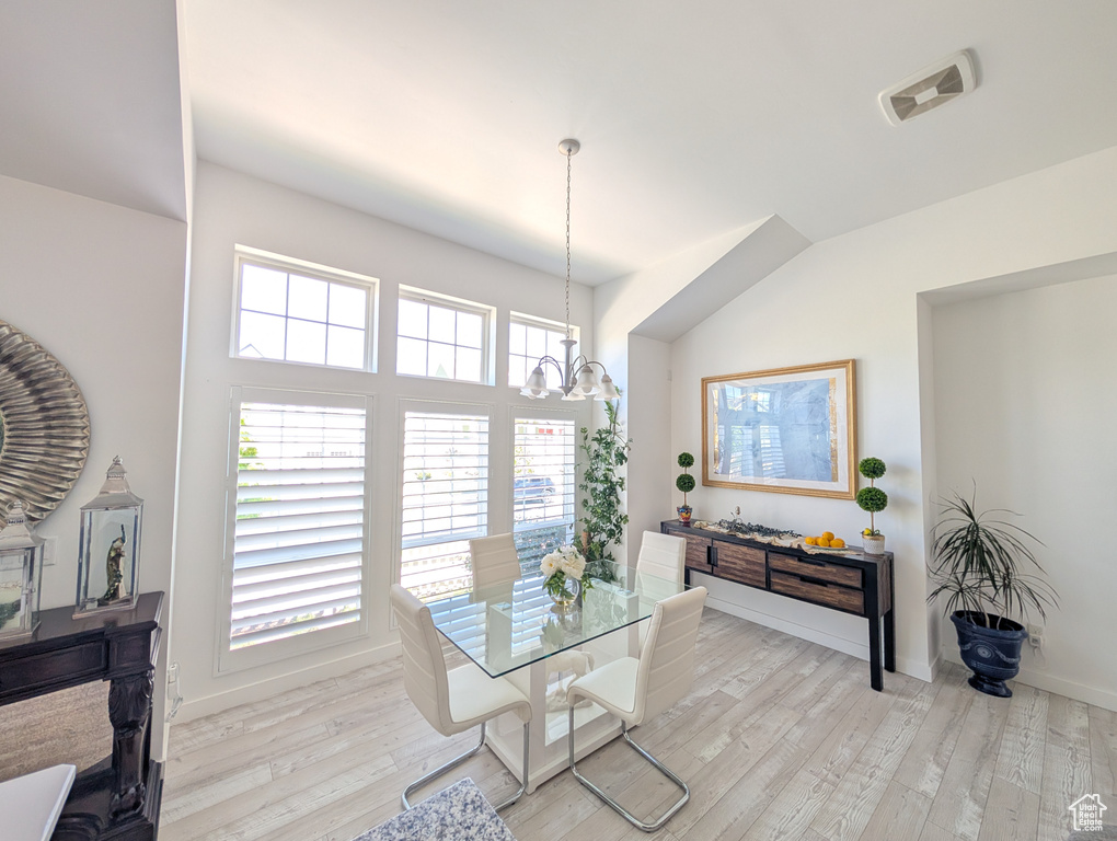 Dining space featuring a chandelier, light wood-style flooring, and baseboards