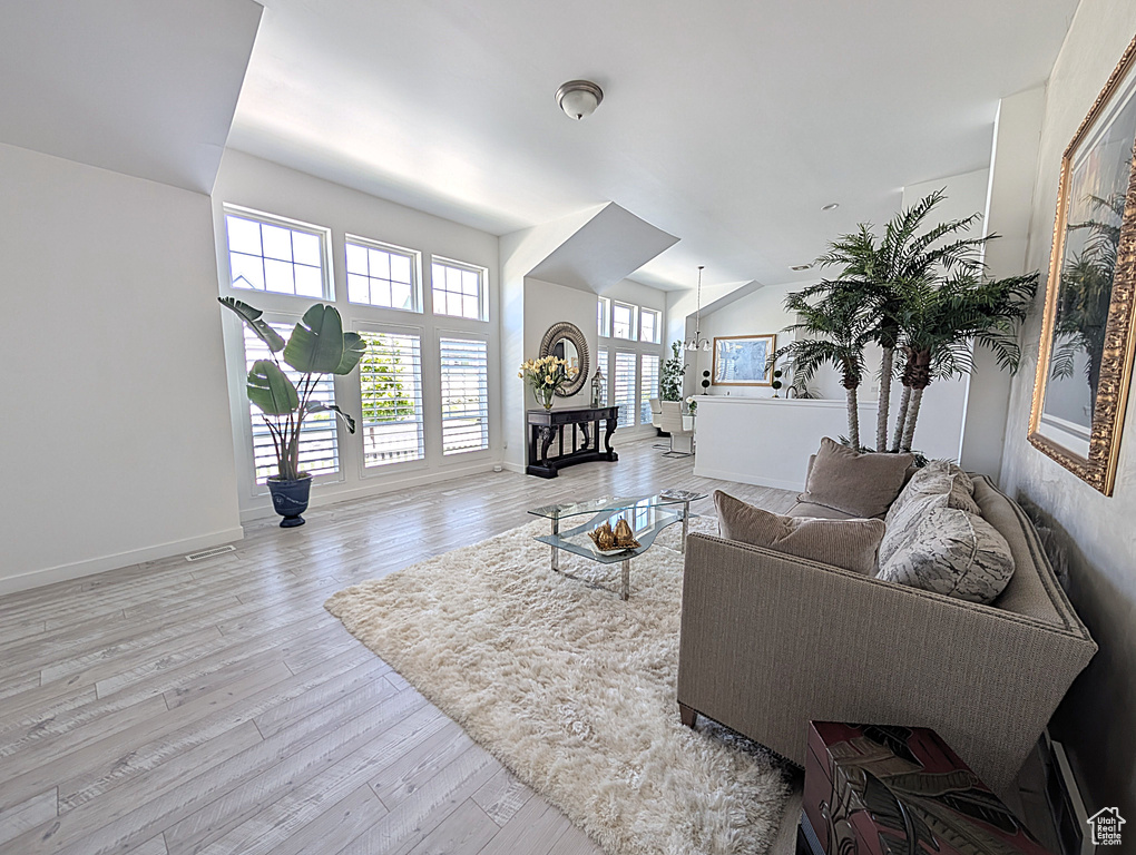 Living area with light wood-style flooring and baseboards