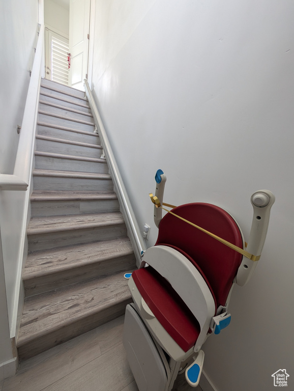 Stairs with baseboards and wood finished floors