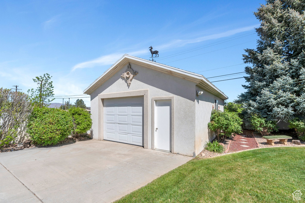 Detached garage with concrete driveway