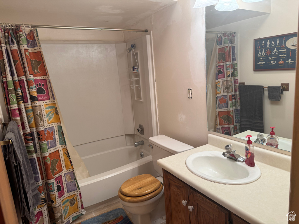 Full bath featuring toilet, shower / tub combo, and vanity