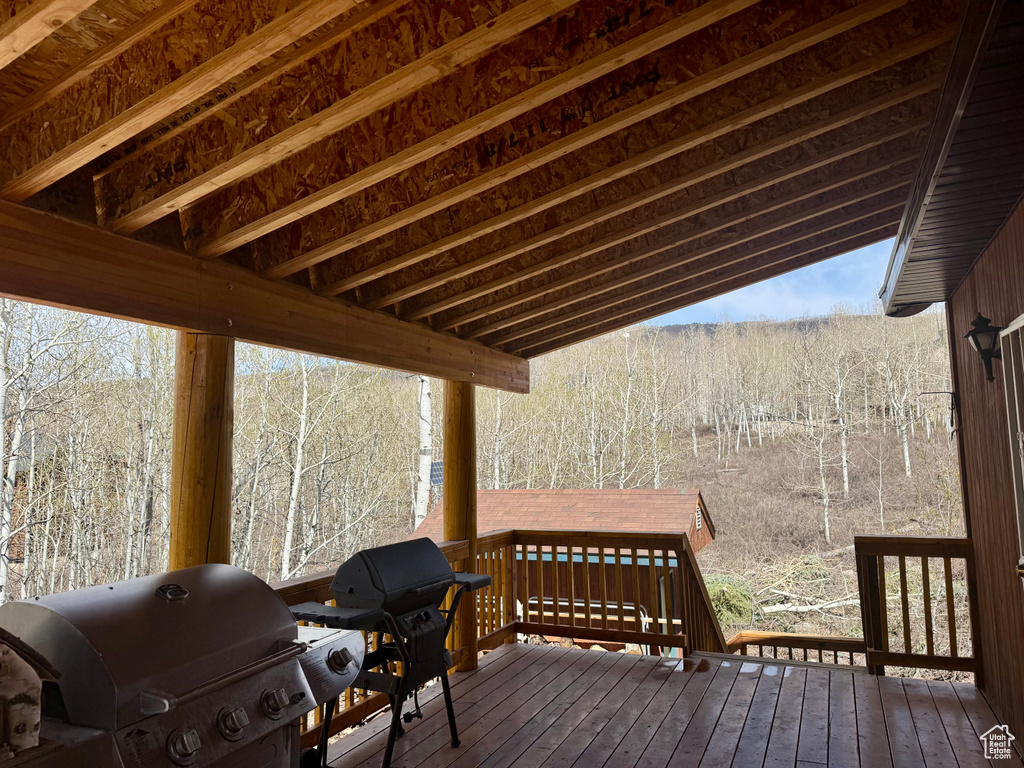 Deck featuring area for grilling and a view of trees